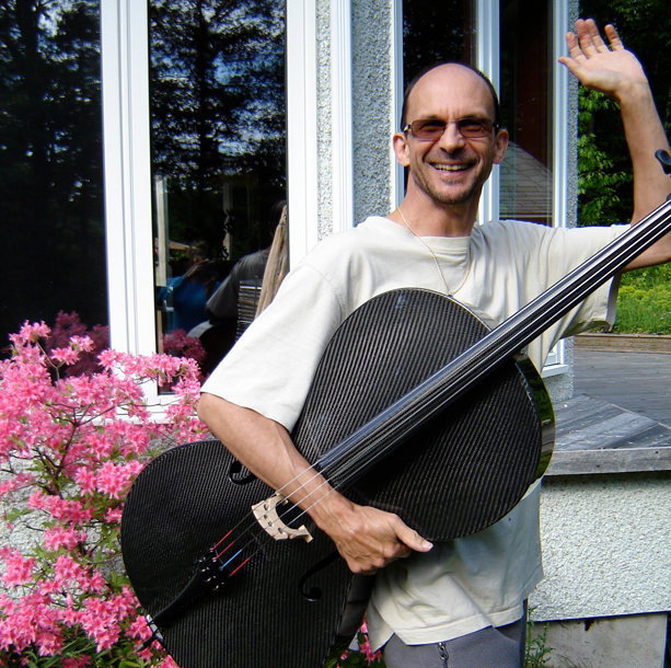 Kalyan waving with cello under arm